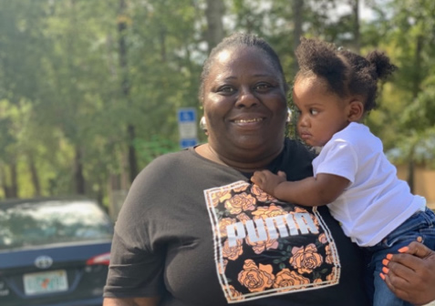 Woman holding small girl